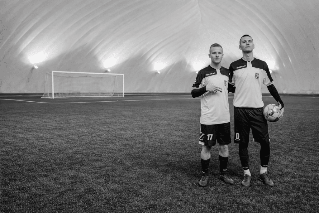 Jugadores con equipaciones Givova en un campo de fútbol cubierto